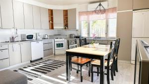 a kitchen with a table and chairs in it at Cozy apartment with sauna in Haapavesi