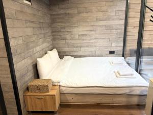 a bed in a room with a brick wall at Slana bara glamping in Slana Bara