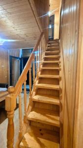 a wooden staircase in a room with wooden walls at kotej lazi in Itʼkhvisi +2 photos