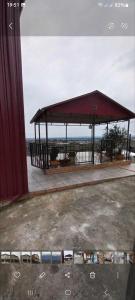 a pavilion on a building with the ocean in the background at kotej lazi in Itʼkhvisi