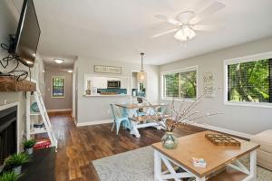 a living room with a fireplace and a table at 19 Pinehurst in Oak Island