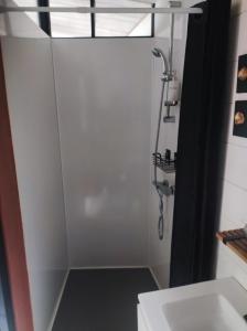 a shower stall in a bathroom with a sink at La cabane zen in Saint-Martin-des-Champs
