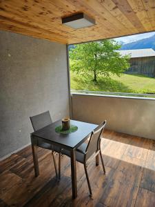 a table and chair in a room with a window at Chesa Bunita Dus in Gaschurn