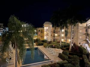 a view of a hotel with a swimming pool at night at Island Getaway I Beach Access Across Street in Marco Island