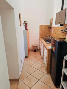 萨萨里Mulino 1的一间配备有黑色冰箱的厨房和瓷砖地板