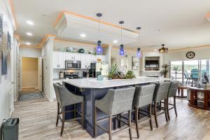 a kitchen with a large island with chairs around it at Lake of the Ozarks Retreat with Waterfront View! in Lake Ozark