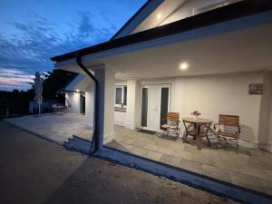 a patio with two chairs and a table on a house at Vibe Residence Suceava in Suceava