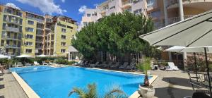 a swimming pool in the middle of a building at Vanilla Garden Apartments in Sunny Beach