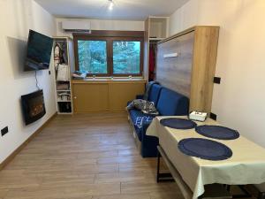 a living room with a couch and a table in it at Aral in La Pinilla