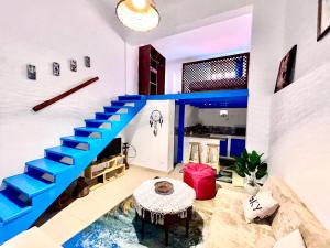 a living room with blue stairs and a table at Amnesia Residence in Naama Bay - Downtown in Sharm El Sheikh