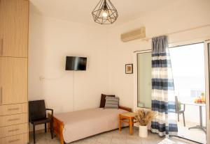 a small bedroom with a bed and a window at Sunrise Studios in Megalochori