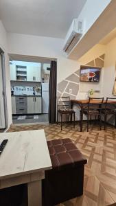 a living room with a table and a kitchen at CoraHome Ultra Central in Corabia