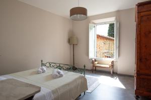 a bedroom with a bed and a window at The Clock Tower View Loft in Montecatini Alto