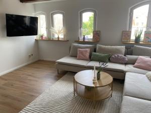 a living room with a couch and a table at Ferienwohnung Altstadt Frankenstraße in Stralsund