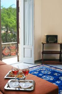 a table with two glasses of wine and a plate of food at The Clock Tower View Loft in Montecatini Alto +22 photos