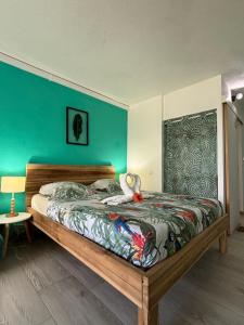 a bedroom with a bed with a stuffed animal on it at Suite Blue Diamond vue mer in Le Diamant