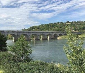 a large bridge over a river with a bridge at Charmant petit appartement avec terrasse in Agen