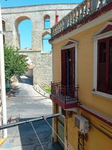 a view of a building with a balcony and a street at C a M A R E S in Kavala