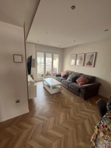 a living room with a couch and a table at Apartamento Recién reformado en EL TOYO in Retamar +23 photos