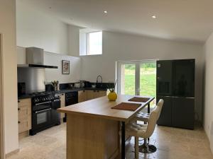 a kitchen with a wooden table and a counter top at Gite le pèlerin in Sault-de-Vaucluse