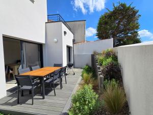 a wooden table and chairs sitting on a patio at Bellevue in Jard-sur-Mer