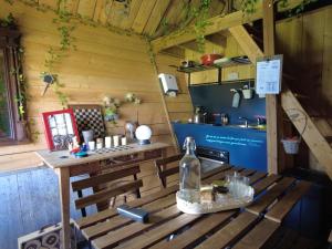 a wooden bench with a table in a kitchen at La Maison Magique in Trignac