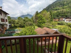 a balcony with a view of a river and mountains at Cà da Nello in Pellizzano
