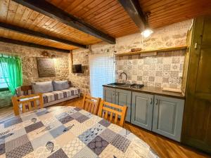 a kitchen with a table and a couch in a room at Voltera Apartments in Betina Old Town, with Parking Nearby in Betina
