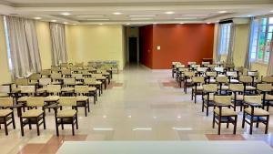 a large room with rows of chairs and tables at Hotel Murialdo in Caxias do Sul