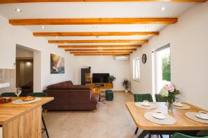 a living room with a table and a couch at House Konavle in Gruda