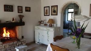 a living room with a table and a fireplace at House Darin dvor in Vela Luka