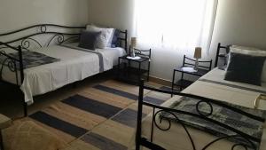 a bedroom with two beds and a window at House Darin dvor in Vela Luka