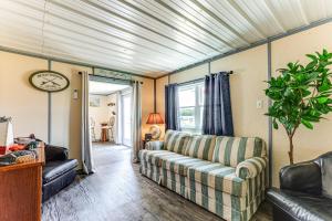 a living room with a couch and a table at Sunrise Landing: Waterfront Cottage in Avenue! in Avenue