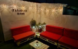 a room with two red couches and a table at LovelyLoft Trafalgar in Alicante
