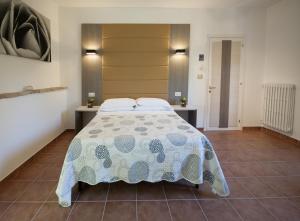 a bedroom with a large bed and two tables at Antica Melegnano in Atri
