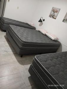 two beds sitting on the floor in a room at Quinta Ogarupa in Corrientes