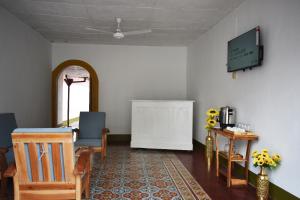 a living room with two chairs and a tv at Casa Girasol in Granada