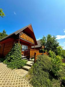 a house with stairs leading up to it at Sielanka - Domki Całoroczne in Bezmiechowa Dolna
