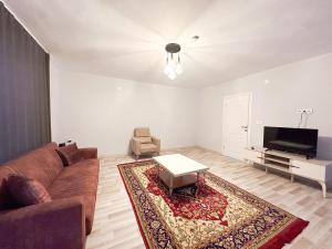a living room with a couch and a table at Mukka Apart Hotel - شقق موكا الفندقية in Trabzon