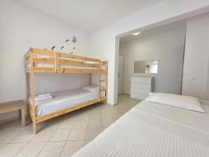 a bedroom with two bunk beds and a mirror at Casa Marjardin Hanioti 2025 in Hanioti