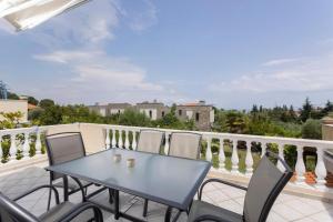 a blue table and chairs on a balcony at Casa Marjardin Hanioti 2025 in Hanioti