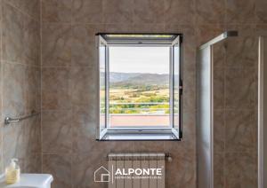 a bathroom with a shower with a window at Casa da Escusa by ALPONTE in Caminha +52 photos