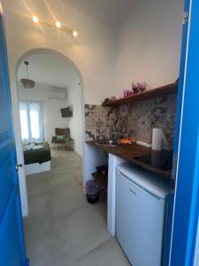 a kitchen with a sink and a counter top at Nikosgardenplacebythesea in Amorgos