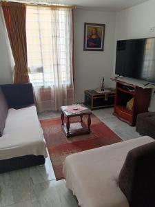 a living room with a couch and a tv at Home Sweet Home Luxury Paipa in Paipa +15 photos