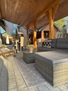 an outdoor patio with a couch and a table at Country house in Dziemiany +35 photos