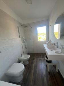 a white bathroom with a toilet and a sink at New ! Rayuela San Pantaleo in San Pantaleo