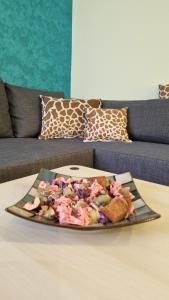 a plate of food on a table in front of a couch at Apartman Pegaz in Lazarevac +21 photos