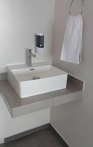 a bathroom with a white sink and a towel at SUITE DALIA, AA, cocineta, baño privado, ubicación in Tepic