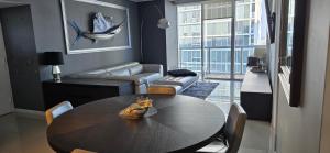 a living room with a dining room table and a whale painting at Miami brickell condo ocean view in Miami