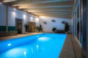 a large swimming pool in a house with blue lighting at Dauscher Hof Natur Pur in Inzell